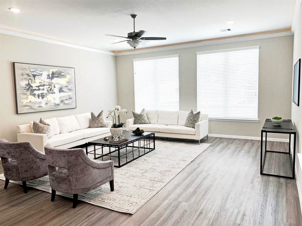 a living room with a couch and chairs and a table