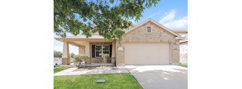 a house with a garage door in front of it
