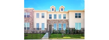 a large brick building with a grassy yard in front of it