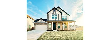 a house with a green lawn and a blue sky in the background