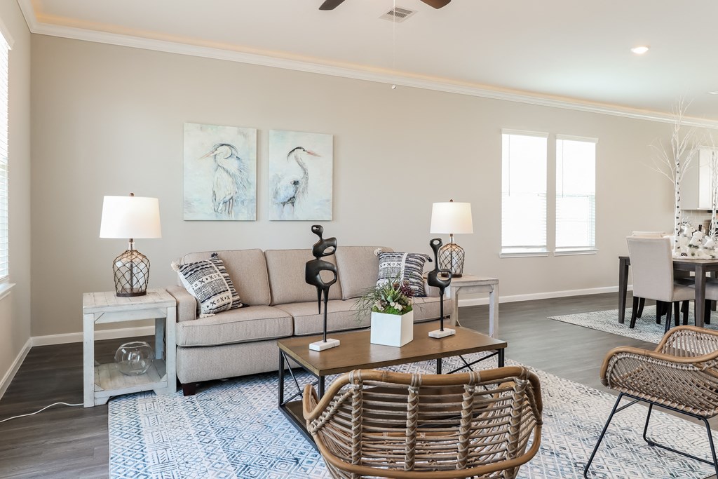 a living room with a couch and chairs and a table
