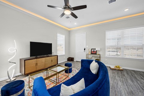 A living room with a blue chair and a television.