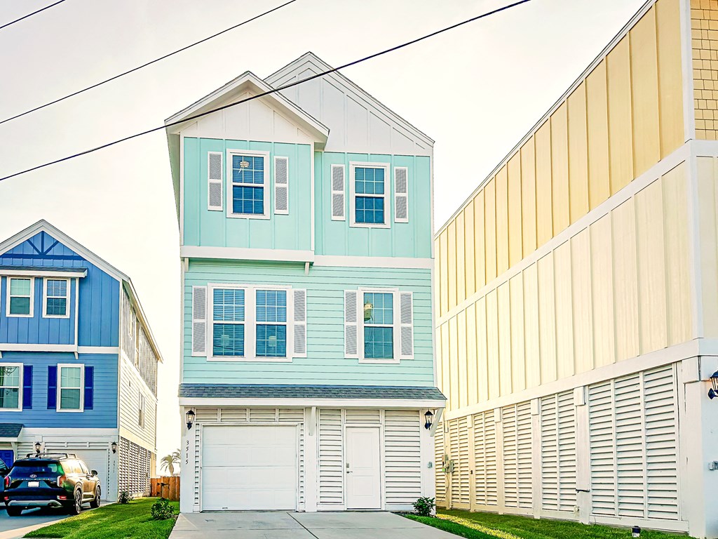 a blue house in front of a row of houses