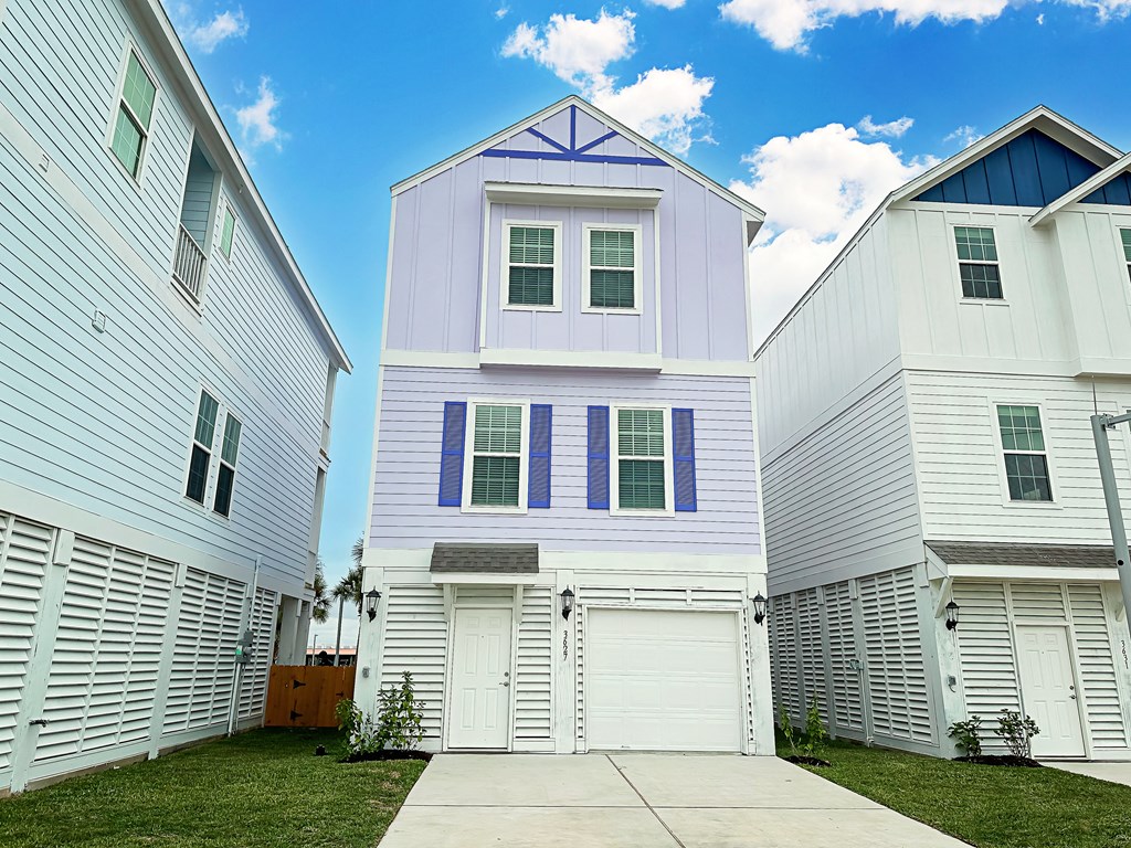 a white house with blue shutters and a sidewalk