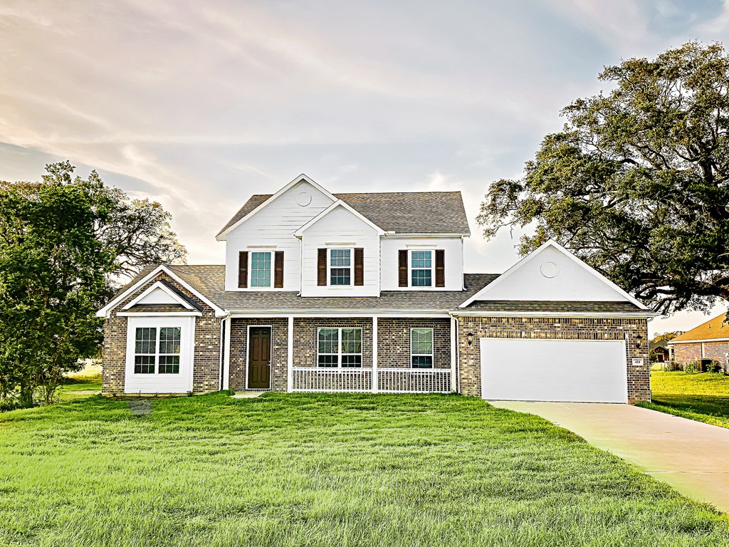 a house with a white garage door and a lawn