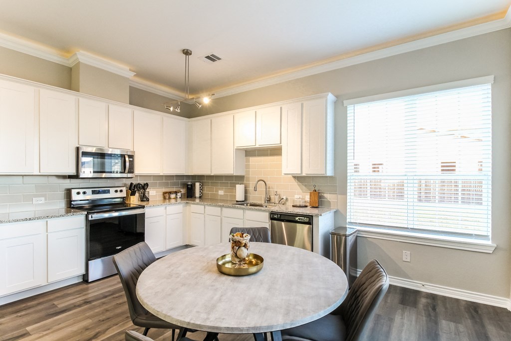 Open floor plan style kitchen with stainless steel appliances