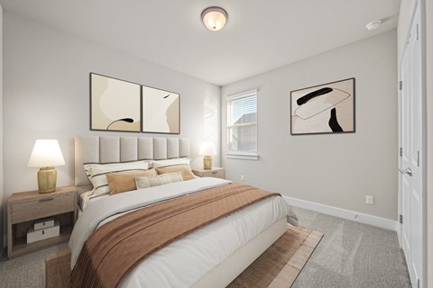 A bedroom with a large bed and two lamps on side tables.