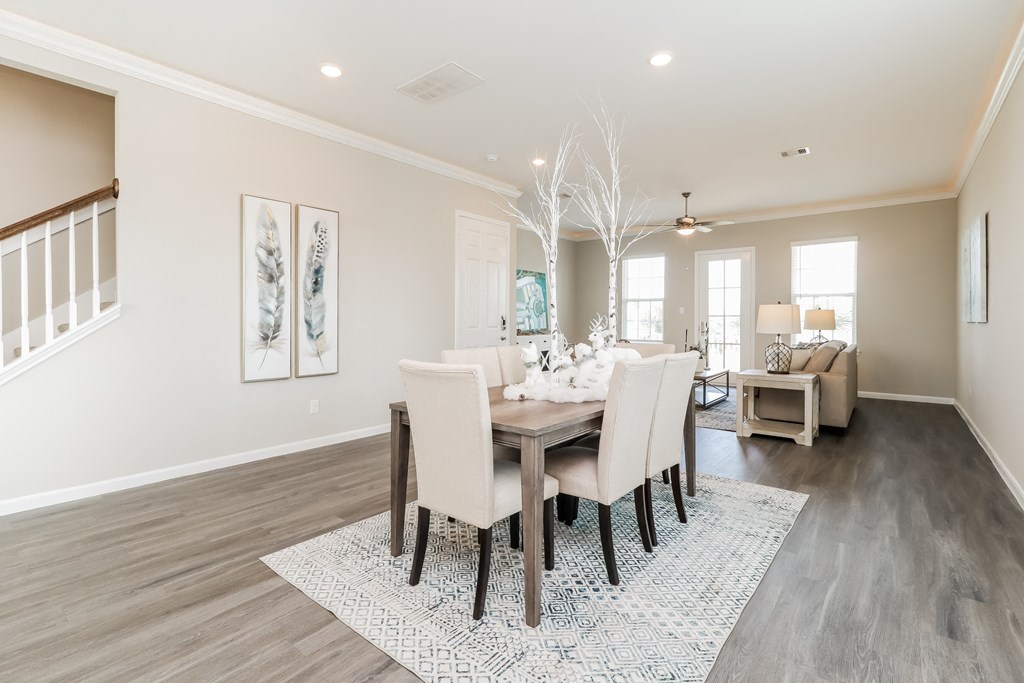a dining room and living room with a table and chairs