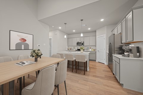 A modern kitchen with a dining table and chairs.