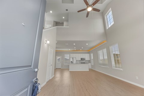 A spacious room with a ceiling fan and a window.