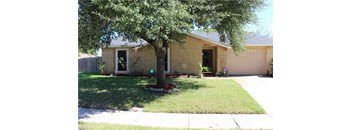 a house with a tree in front of it