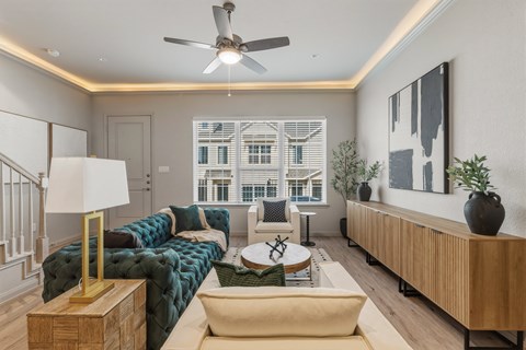 A living room with a green sofa and a wooden coffee table.
