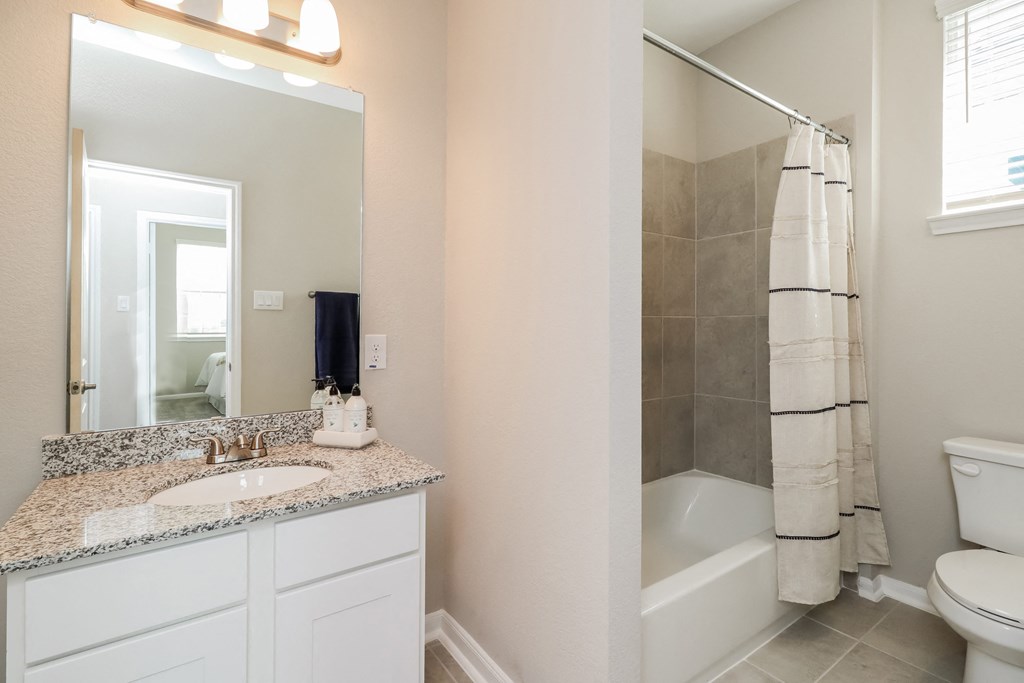 a bathroom with a sink and a shower and a toilet