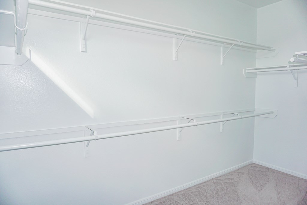 a large empty closet in a room with white walls