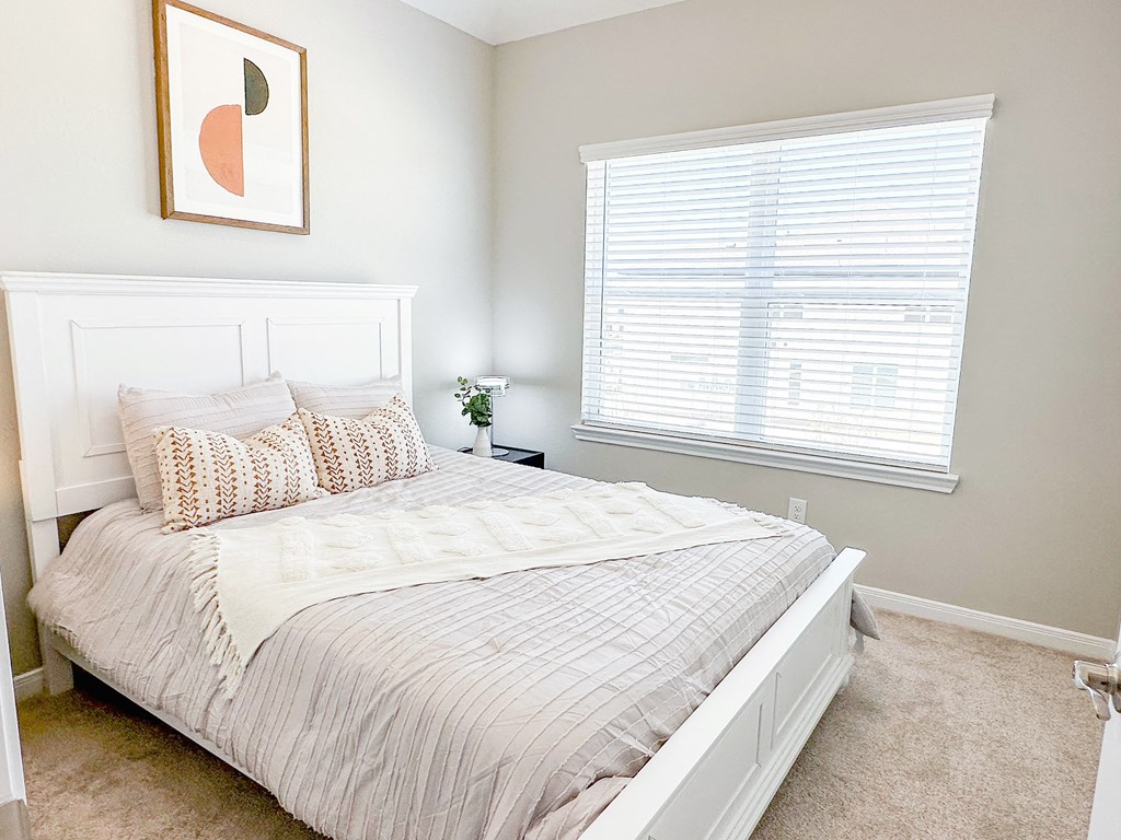a bedroom with a large bed and a large window at Enclave at Mason Creek, Texas