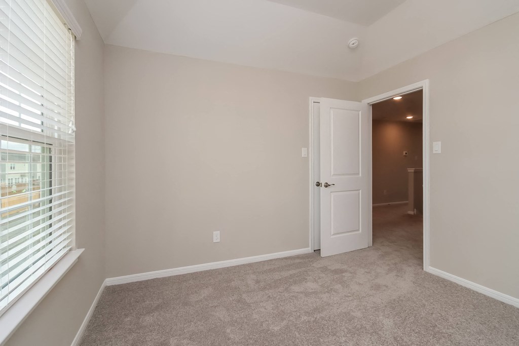 Carpeted Bedroom at Pradera Oaks in Bonney, Texas