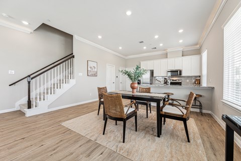 a dining room with a table and chairs