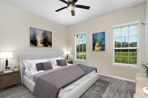 a bedroom with a bed and a ceiling fan