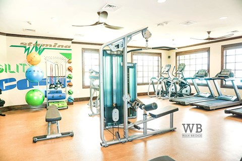 A gym with a variety of equipment including a leg press machine.
