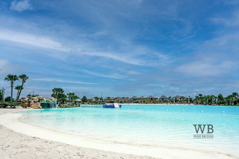 A beautiful beach with clear blue water and white sand.