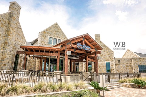 A building with a wooden entrance and a sign that says "WB Wain Bridge".