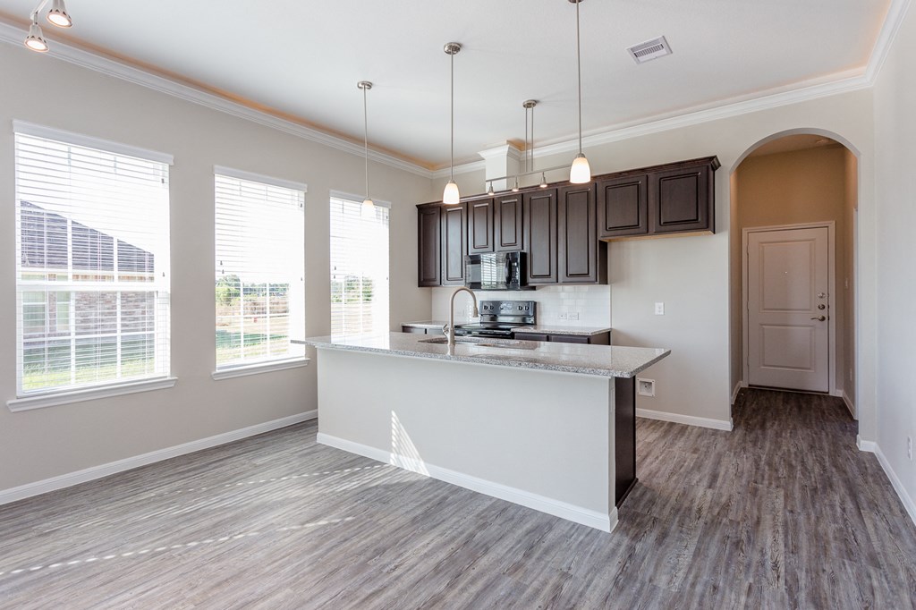 an open kitchen and living room with a large window
