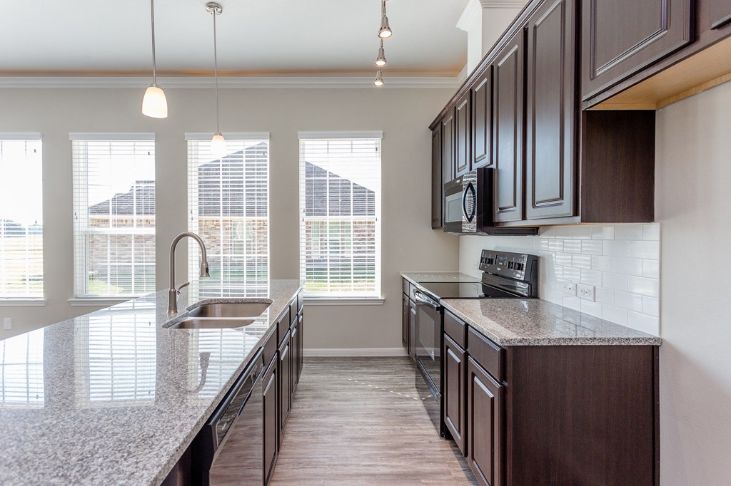 a kitchen with granite counter tops and a sink