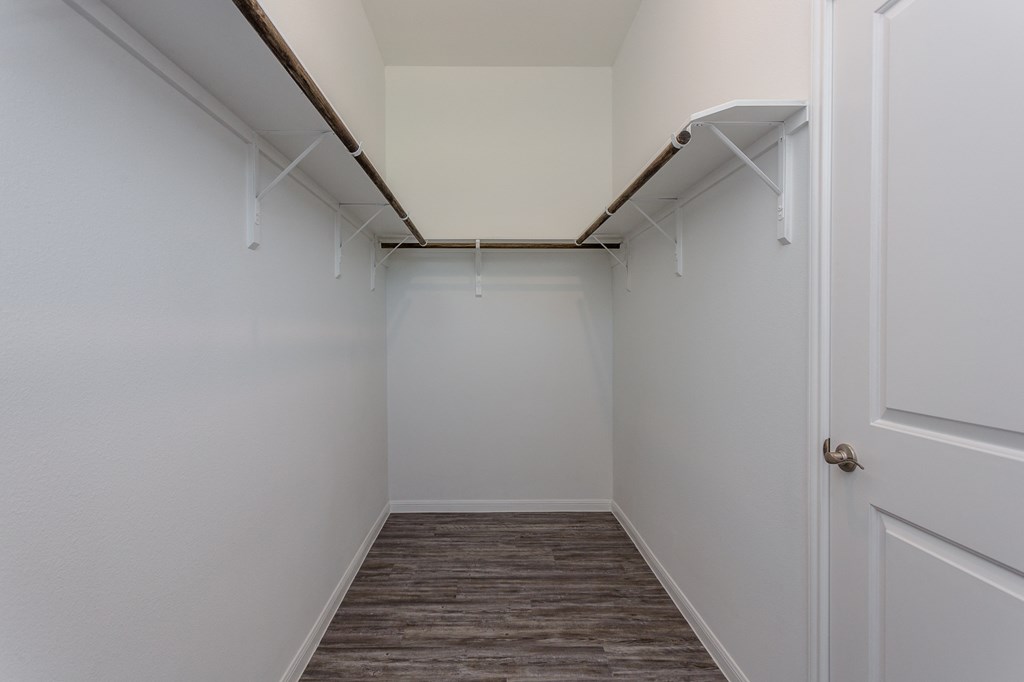 an empty room with white walls and a closet
