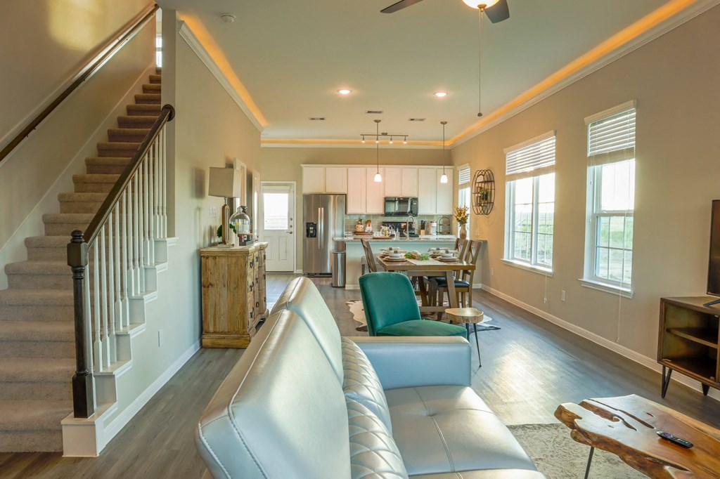a living room with a couch and a staircase