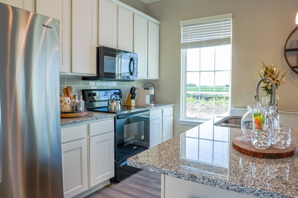 a kitchen with stainless steel appliances and granite counter tops
