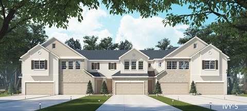 A large, two-story house with a garage is surrounded by trees and has a driveway leading to the front door.