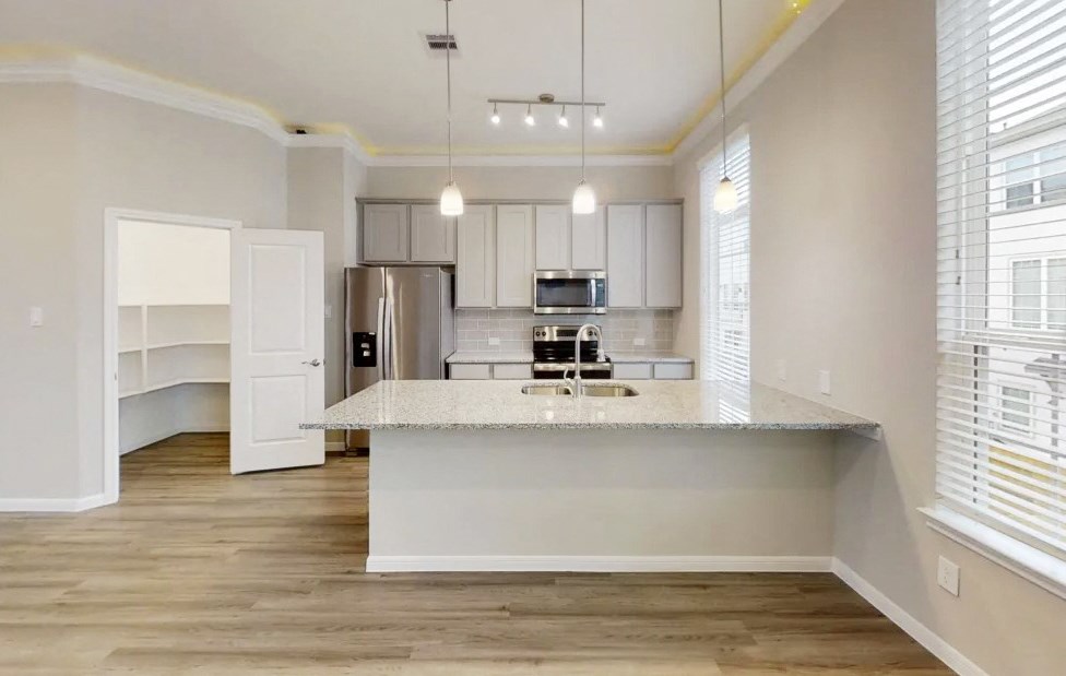 a kitchen with a counter top and a refrigerator