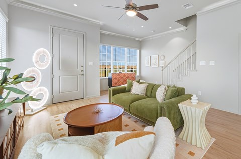 A living room with a green couch and a wooden table.