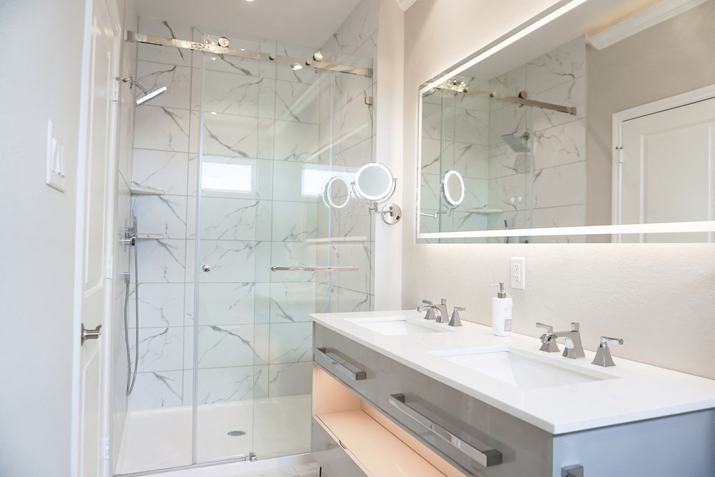 a bathroom with a large mirror and two sinks at Enclave at Mason Creek, Katy,TX