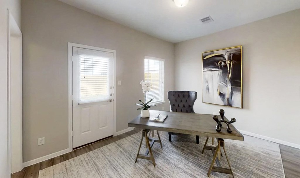 an office with a desk and a chair and a door