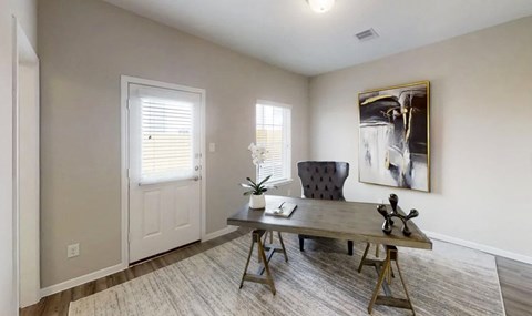 an office with a desk and a chair and a door
