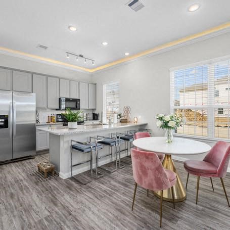 a kitchen with a table and chairs and a refrigerator