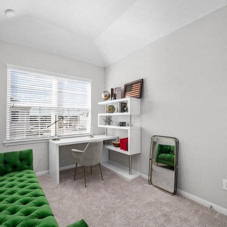 a room with a desk and a chair and a mirror