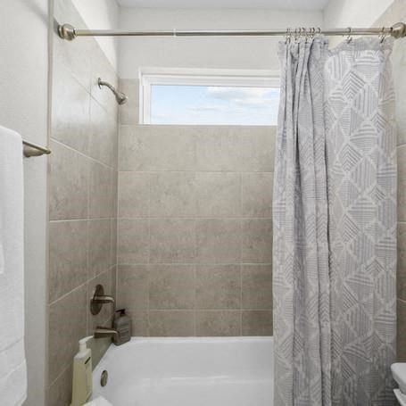 a bathroom with a shower curtain and a bath tub