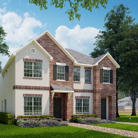 a large brick house with a lawn and trees
