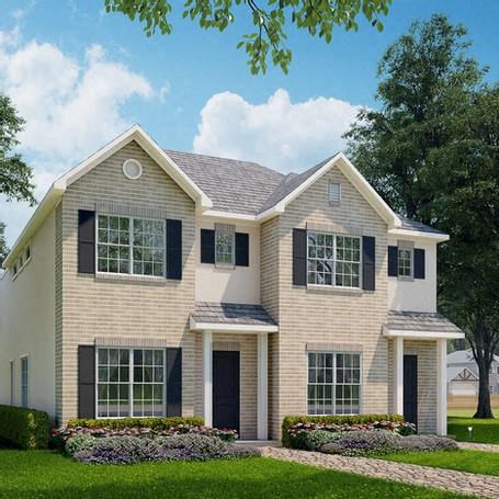 a white house with black shutters and a lawn