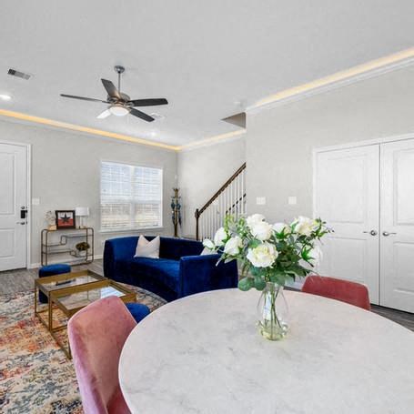 a living room with a white table and a blue couch