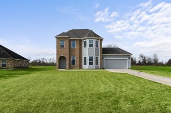 a home with a green lawn