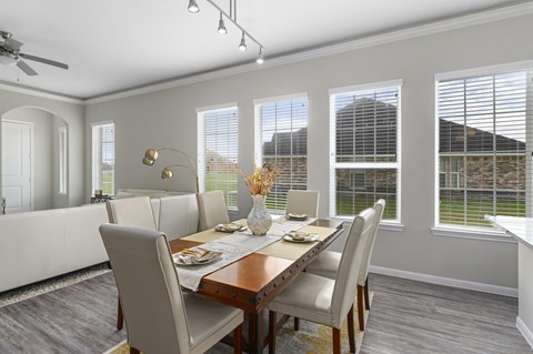 A dining room with a table set for four.