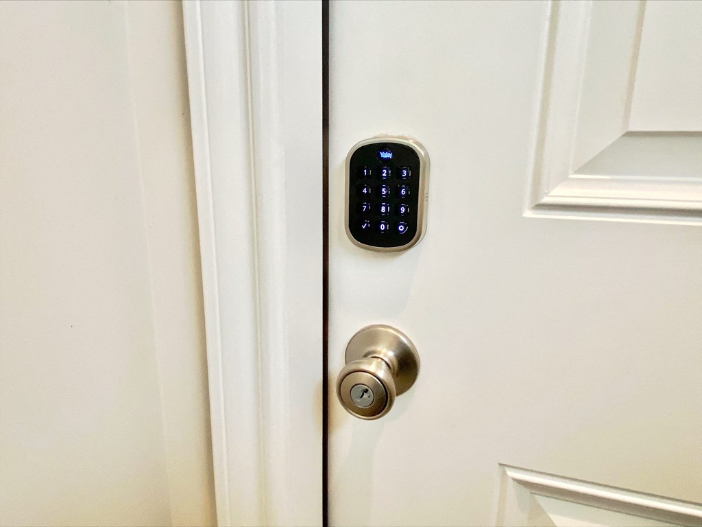 an open door with a remote control on the door handle