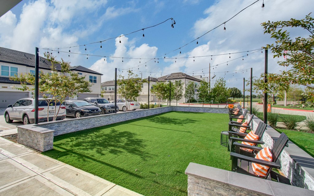 a yard with lawn chairs and a pool
