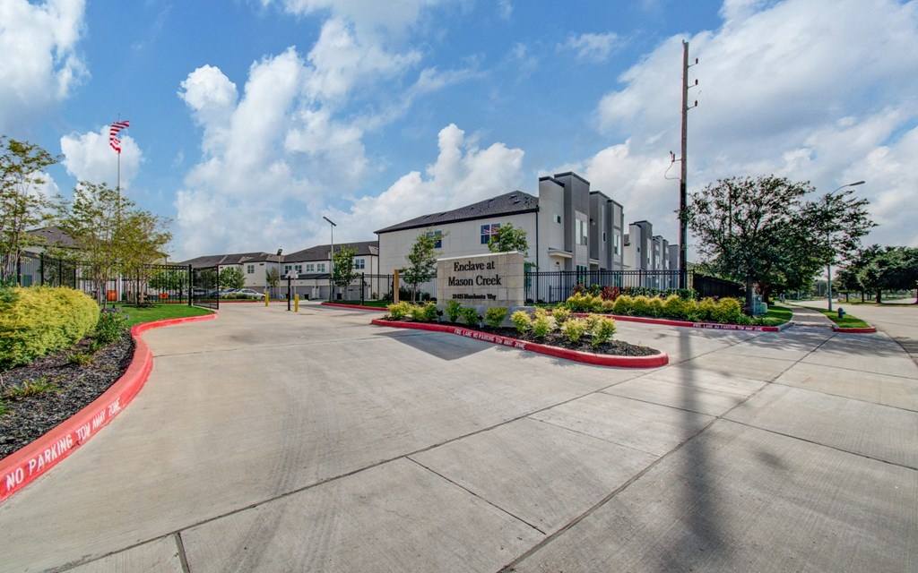 an empty parking lot with a building in the background at Enclave at Mason Creek, Katy,TX