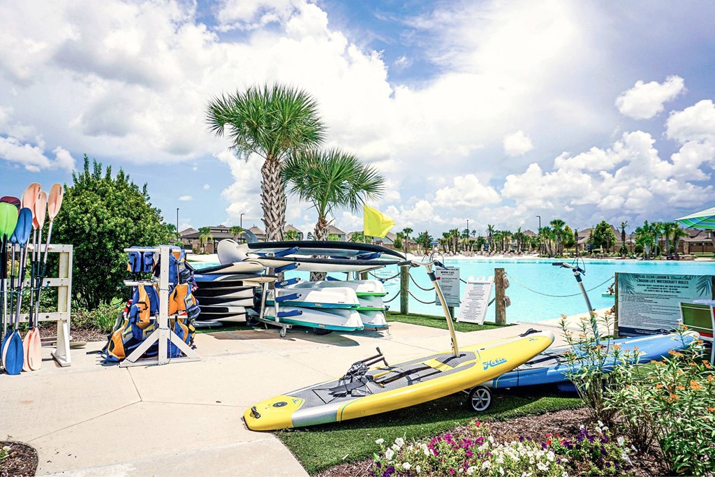 A yellow kayak is on display in front of a pool.