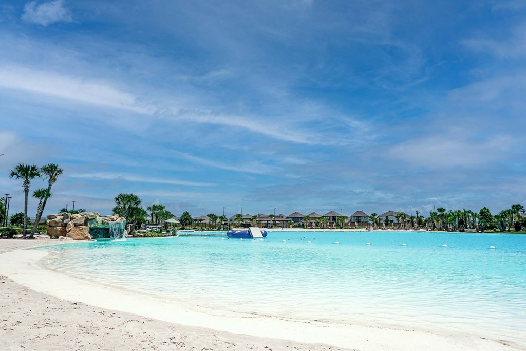 A beautiful beach with clear blue water and white sand.