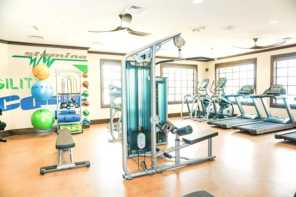 A gym with a variety of equipment including a leg press machine.